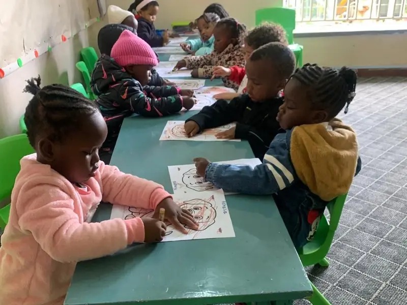 Children colouring at desks
