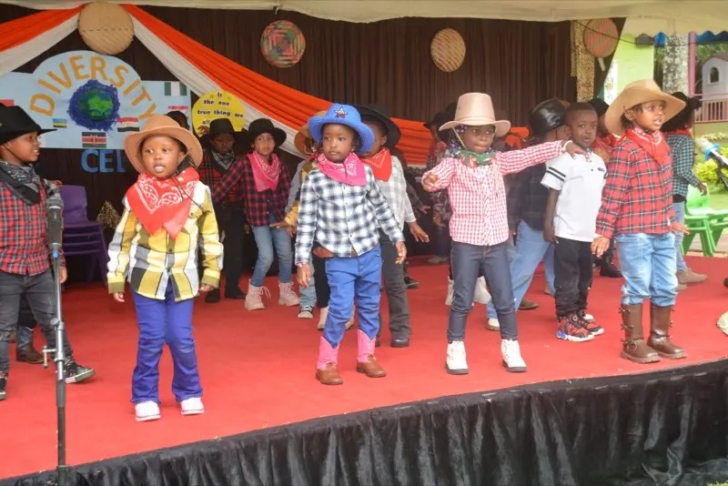Children dancing in cowboy hats