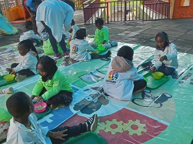 Children doing hands-on craft activities outdoors