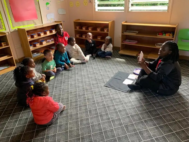 Teacher reading to children at circle time