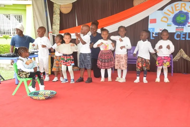 Children performing in African-print outfits on Diversity Day