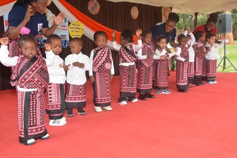 Toddlers in colourful wraps during the parade